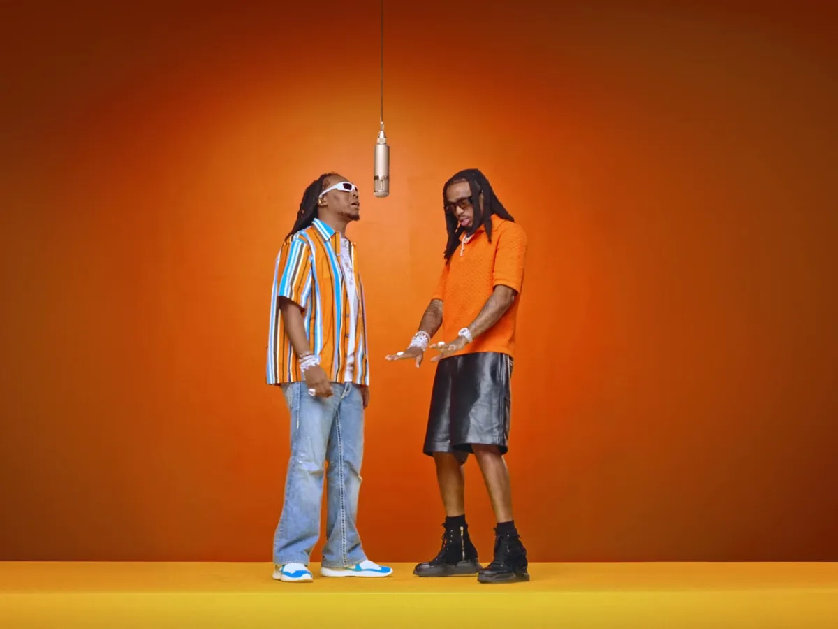 Wide source frame showing both original performers at 18 seconds into the trimmed clip